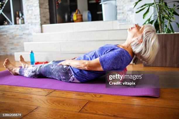 foam roller massage for lower back pain - injury prevention stock pictures, royalty-free photos & images