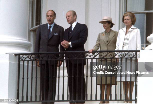 French President Valery Giscard d'Estaing and US President Gerald Ford stand together on a balcony at the White House during the former's State...