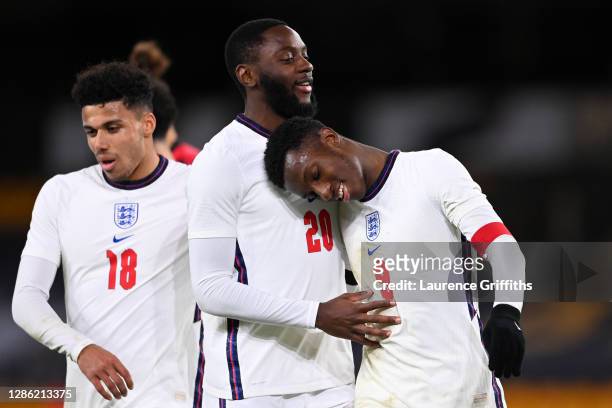 Eddie Nketiah of England celebrates with teammates Josh Dasilva and James Justin after scoring their team's fifth goal during the UEFA Euro Under 21...