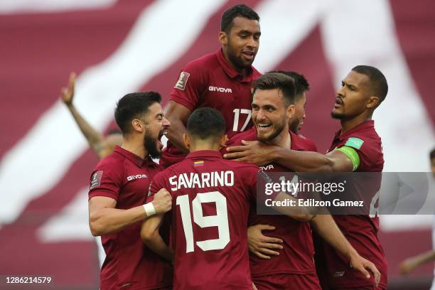 Luis Mago of Venezuela celebrates with teammates after scoring the first goal of his team during a match between Venezuela and Chile as part of South...