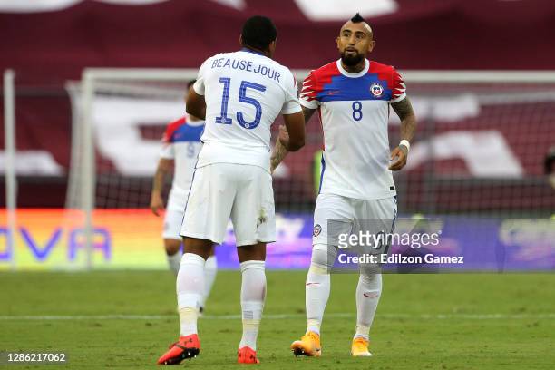 Arturo Vidal of Chile celebrates with teammate Jean Beausejour after scoring the first goal of his team during a match between Venezuela and Chile as...