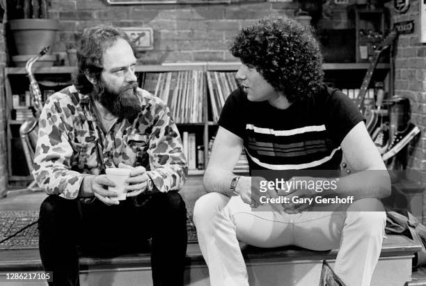 View of Scottish Rock musician Ian Anderson , of the group Jethro Tull, and VJ Mark Goodman as they sit on a low stage during an interview at MTV...