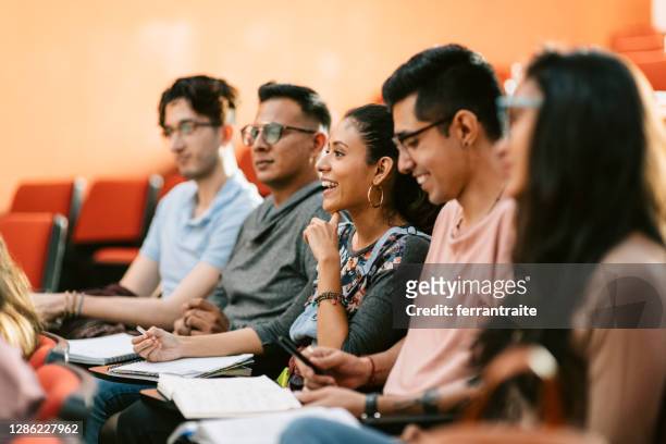 students attending a lesson in lecture hall - latin american and hispanic ethnicity student stock pictures, royalty-free photos & images