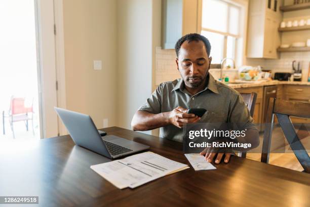 man paying bills and banking online - man taking photos stock pictures, royalty-free photos & images