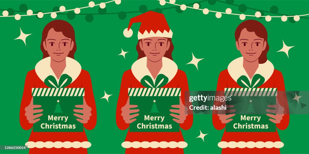 Three smiling beautiful teenage girls dressed in a Santa Claus suit holding a Christmas present, gift box