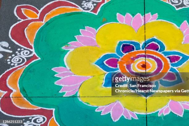 Rangoli, a colorful form of Indian folk art celebrating art, beauty and culture, are seen drawn on the sidewalks of Bishop Ranch City Center to...