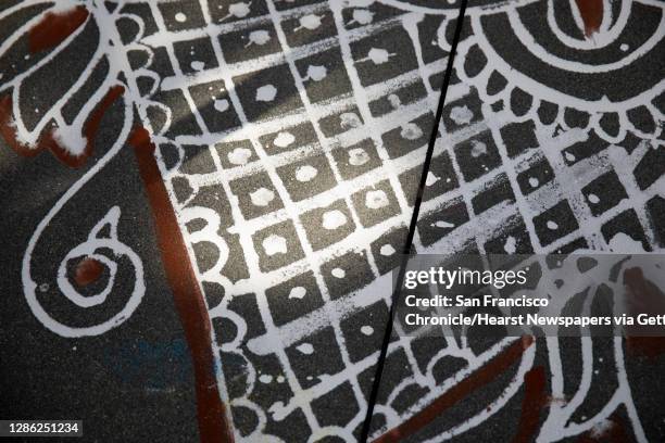 Rangoli, a colorful form of Indian folk art celebrating art, beauty and culture, are seen drawn on the sidewalks of Bishop Ranch City Center to...