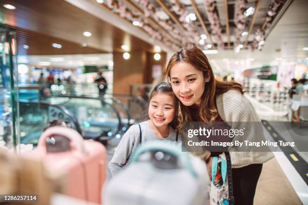 mom & daughter shopping for home appliances joyfully in department store - home appliances ストックフォトと画像