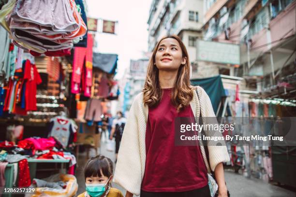 mom & daughter exploring and walking through local market stalls in hong kong - street market stock pictures, royalty-free photos & images
