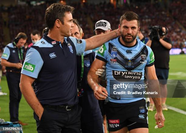 Blues coach Brad Fittler checks on James Tedesco of the Blues after he collided with an opponent during game three of the State of Origin series...