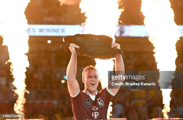 Daly Cherry-Evans of the Maroons celebrates victory as he holds up the winners shield after game three of the State of Origin series between the...