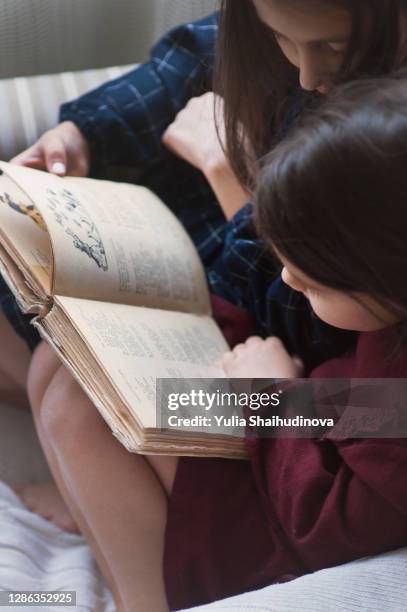 sisters are reading a book - fairytale alphabet stock pictures, royalty-free photos & images