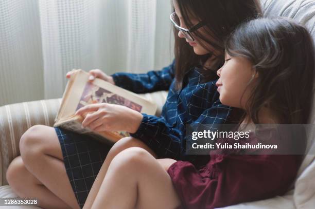 sisters are reading a book - fairytale alphabet stock pictures, royalty-free photos & images