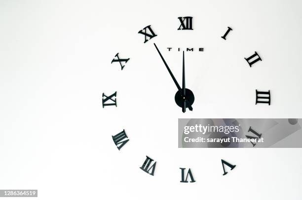 white background roman numerals clock new year's countdown timer hand - reloj antiguo fotografías e imágenes de stock