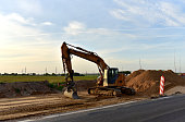 Excavator On Earthworks and Road Construction in City
