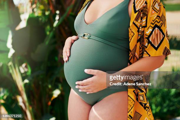 my baby bump is my best accessory - swimming suit stock pictures, royalty-free photos & images