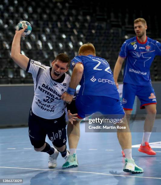 Doman Sikosek of Flensburg challenges Viachaslau Shumak of Brest during the DELO EHF Champions League group stage match between SG Flensburg...