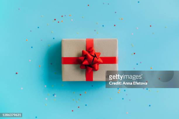 present box on blue background. new year gift. black friday concept. - anna kraft stock pictures, royalty-free photos & images