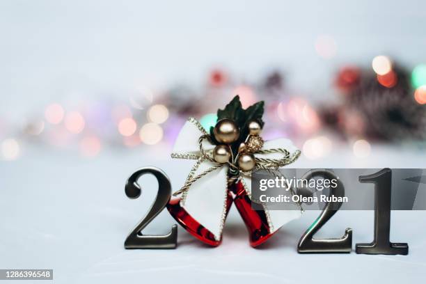 numbers 2021 and red christmas bell with gold ribbon - january 2021 stock pictures, royalty-free photos & images