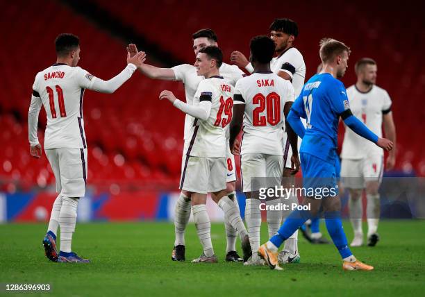 Phil Foden of England celebrates with Jadon Sancho, Declan Rice, Bukayo Saka and Tyrone Mings of England after scoring their team's third goal during...