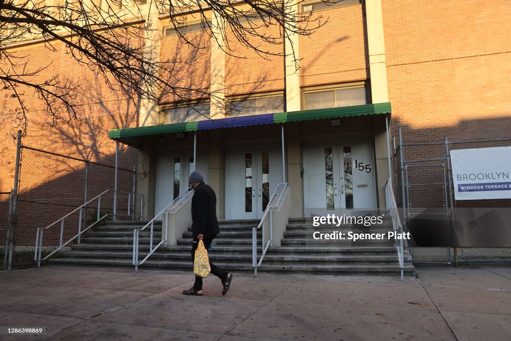 A person walks by a public school in Brooklyn on November 18, 2020 in