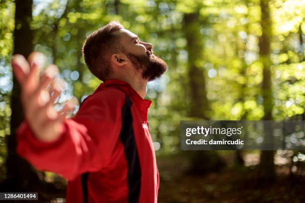 young smiling man enjoying nature - breathing imagens e fotografias de stock