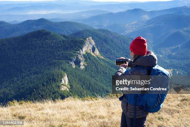 mountaineer takes pictures of the lenses, hiking trail road foothpath apuseni mountains, transylvania, romania. - reservoir model stock pictures, royalty-free photos & images
