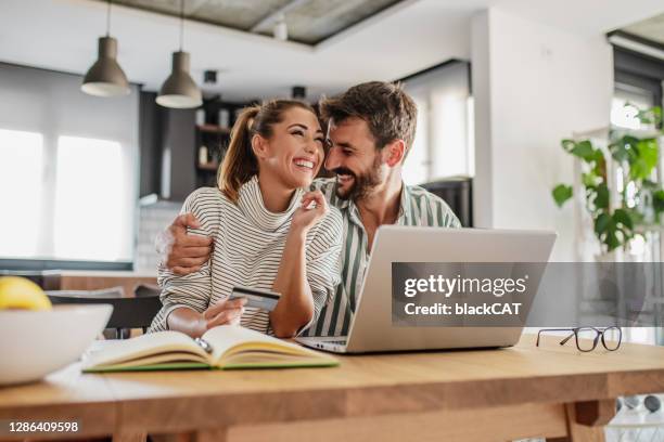 couple is shopping online with credit card at home - shopping excitement stock pictures, royalty-free photos & images