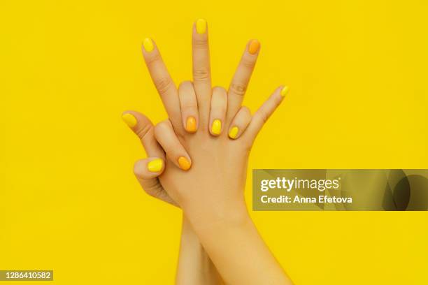 woman in sweater with colorful manicure. trending bright backdrop of the year. perfect nails concept - painting fingernails stock pictures, royalty-free photos & images