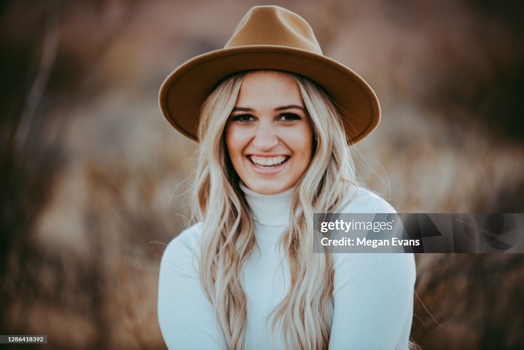Blond Girl White Turtleneck Jeans wearing Tan Hat