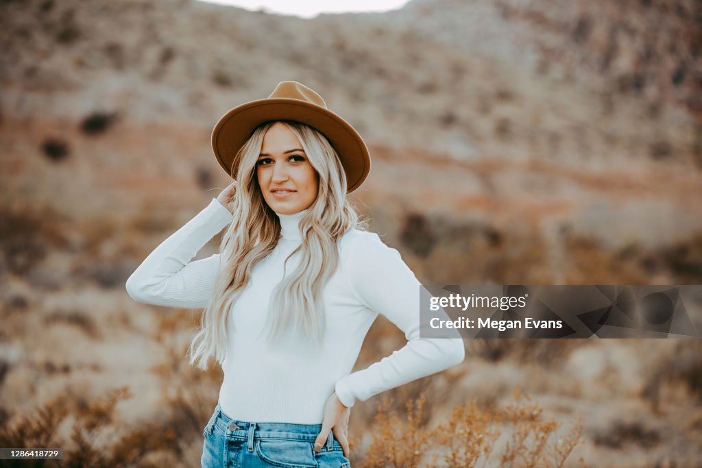 Blond Girl White Turtleneck Jeans wearing Tan Hat