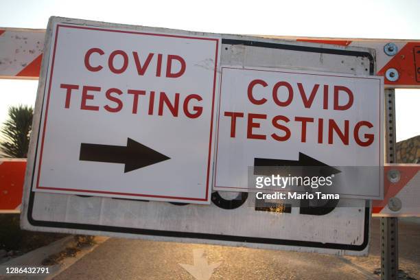 Sign is displayed at a drive-thru COVID-19 testing site amid a surge of coronavirus cases in the city on November 18, 2020 in El Paso, Texas. Texas...