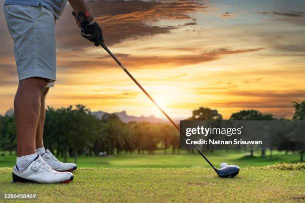 senior golfer doing a golf stroke. - driver golf club stock pictures, royalty-free photos & images