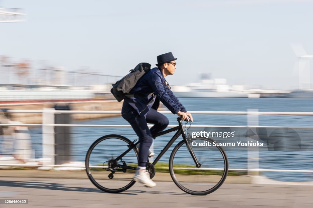 A man rides a bicycle to work in the town of Bayside in the morning
