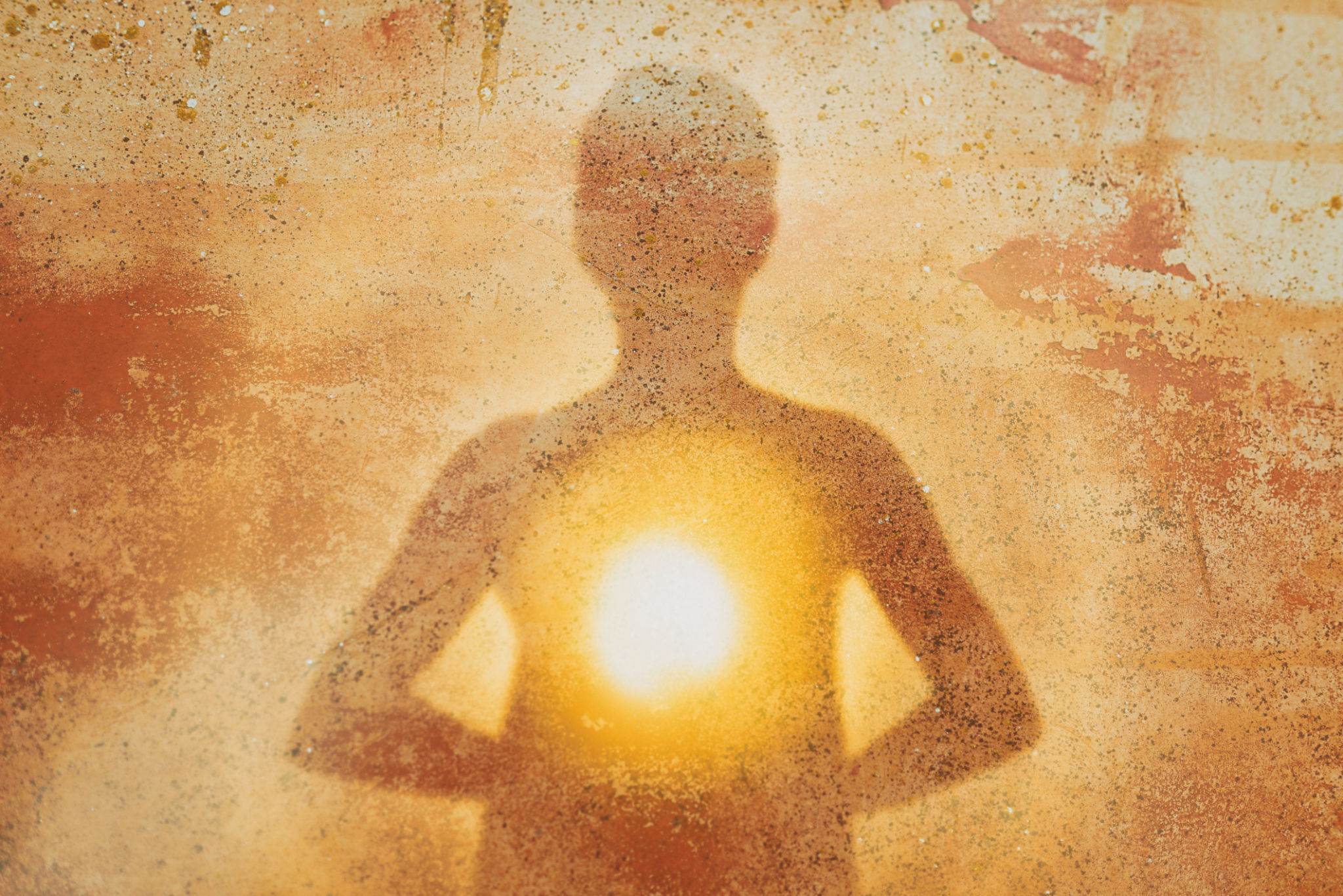 Female silhouette radiating light from within a spiritual heart opening Female silhouette radiating light from within a spiritual heart opening