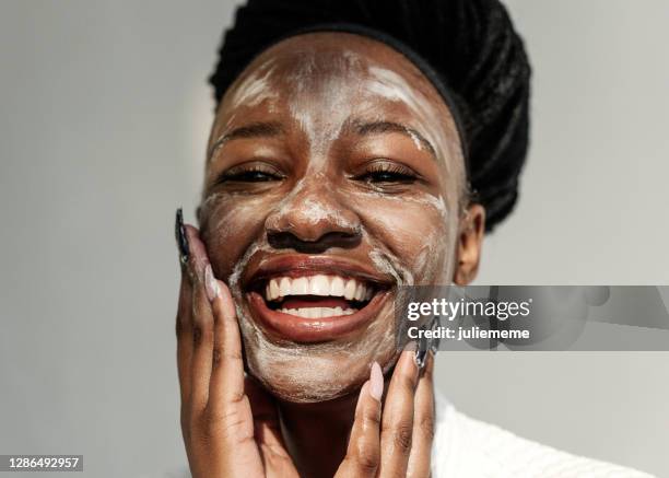 portrait of a smiling woman with a face mask - black skin close up stock pictures, royalty-free photos & images