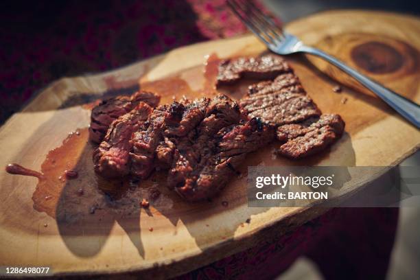 beef steak cut on chopping board - sirloin steak stock pictures, royalty-free photos & images