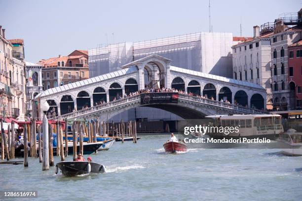The typical boats of Venice, the gondolas in Rialto bridge. Venice , September 11th, 2016