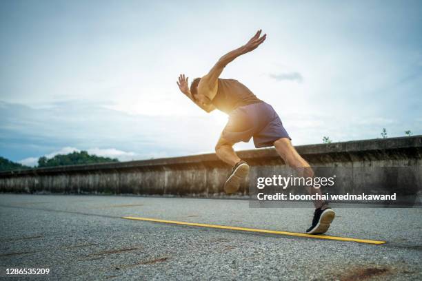 man running jogging on bridge road. health activities, exercise by runner. - marathon start stock pictures, royalty-free photos & images