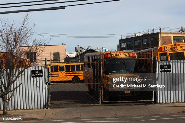 School buses are parked at a bus depot in the Red Hook neighborhood of Brooklyn on November 19, 2020 in New York City. Mayor Bill de Blasio closed...