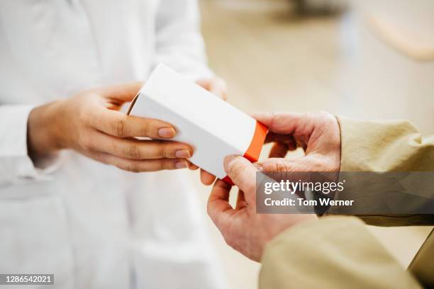 pharmacist giving medication to customer - drug bust stock pictures, royalty-free photos & images