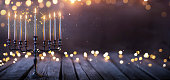 Hanukkah Abstract Defocused Background - Menorah With Bright Dust On Wooden Table