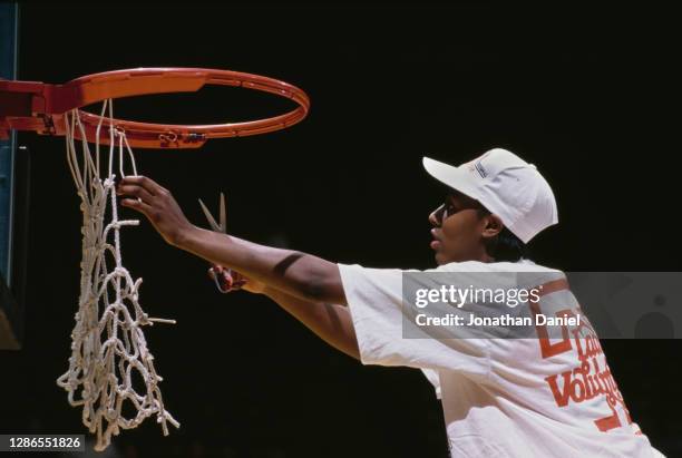 Chamique Holdsclaw, Forward for the Tennessee Lady Volunteers cuts the net on the backboard hoop to celebrate winning the NCAA Division I Women's...