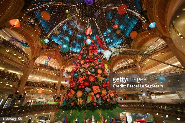 Giant Christmas tree is seen at the empty Galeries Lafayette store on November 19, 2020 in Paris, France. Les Galeries Lafayette store has been...