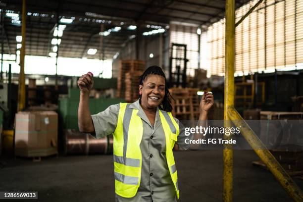 happy mature woman dancing in a industry - dancing funny carefree woman stock pictures, royalty-free photos & images