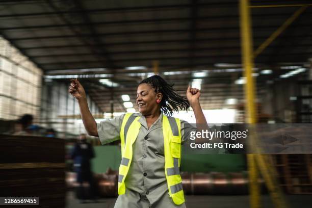 Happy mature woman dancing in a industry