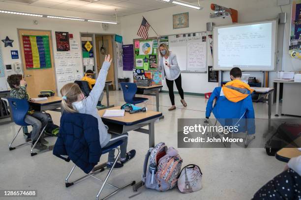 Third grade teacher Cara Denison speaks to students while live streaming her class via Google Meet at Rogers International School on November 19,...