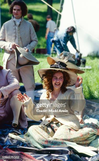 Greta Scacchi adjusts her hat between takes during the filming of 'Jefferson in Paris' in Desert de Retz near Paris, in Chambourcy, France, in May...