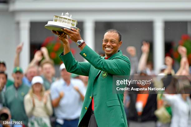 Masters champion Tiger Woods holds up the trophy during the Green Jacket Ceremony following the final round of the Masters at Augusta National Golf...