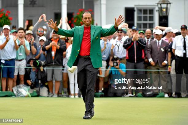 Masters champion Tiger Woods acknowledges the patrons after he was presented with his Green Jacket during the Green Jacket Ceremony following the...